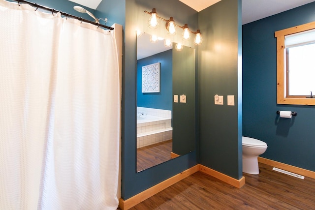 1941 230th St, Saint Croix Falls, WI 54024 - full bath featuring toilet, baseboards, wood finished floors, and curtained shower