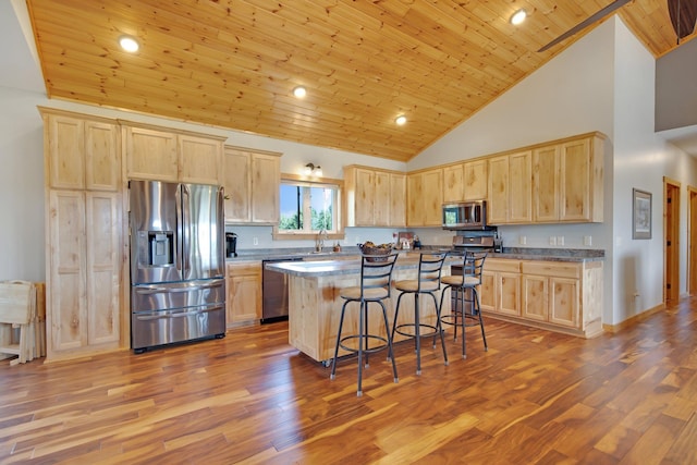 10080 550th St, Rock Creek, MN 55069 - kitchen featuring stainless steel appliances, light brown cabinetry, a sink, wooden ceiling, and high vaulted ceiling