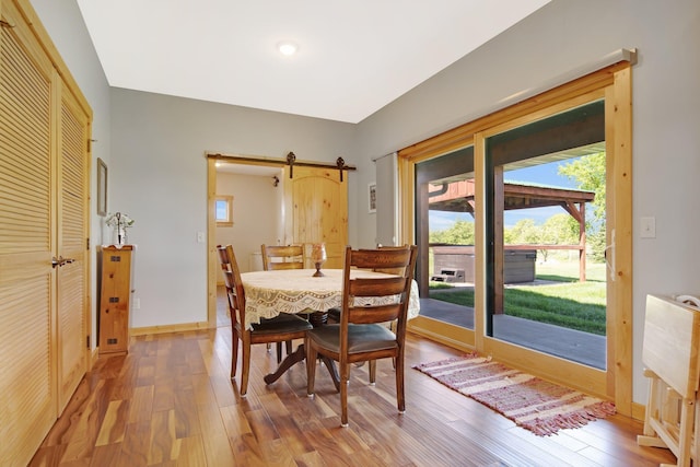 10080 550th St, Rock Creek, MN 55069 - dining room with wood finished floors, a barn door, and baseboards