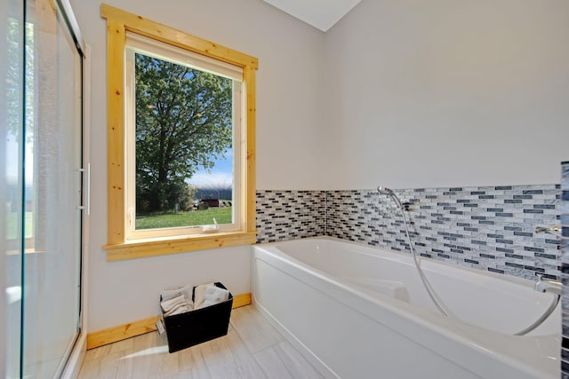 10080 550th St, Rock Creek, MN 55069 - full bathroom with a garden tub, a shower stall, and baseboards