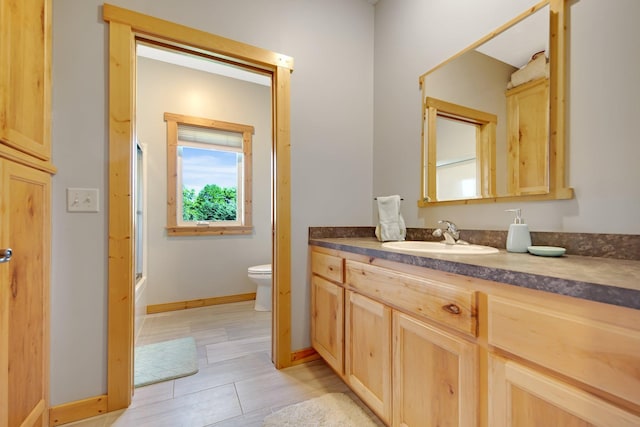 10080 550th St, Rock Creek, MN 55069 - full bathroom with toilet, vanity, baseboards, enclosed tub / shower combo, and tile patterned floors