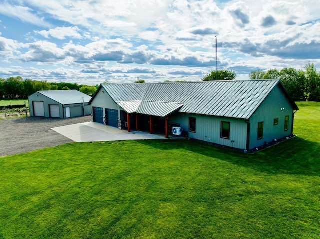 10080 550th St, Rock Creek, MN 55069 - view of front facade with a standing seam roof, an outbuilding, a front lawn, and metal roof