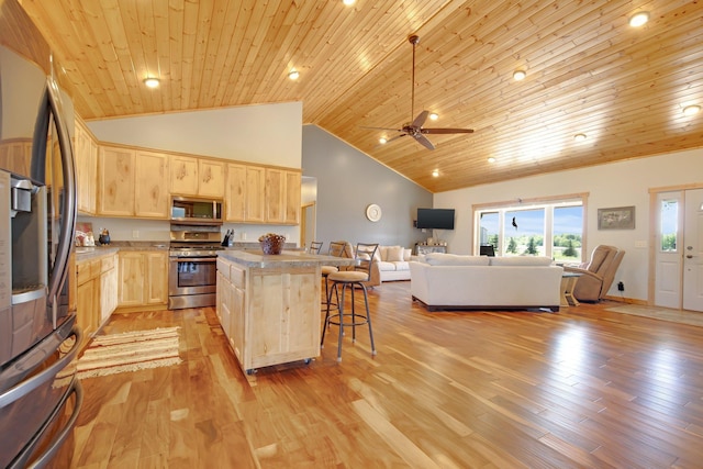 10080 550th St, Rock Creek, MN 55069 - kitchen with appliances with stainless steel finishes, light brown cabinetry, open floor plan, a breakfast bar area, and wooden ceiling