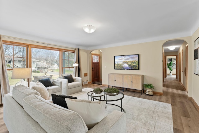 2701 Princeton Ave, Saint Louis Park, MN 55416 - living room featuring arched walkways, wood finished floors, and baseboards