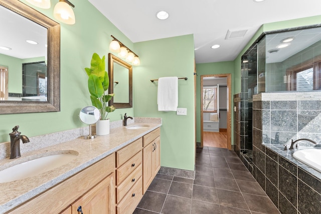 2701 Princeton Ave, Saint Louis Park, MN 55416 - full bathroom with double vanity, a bath, a shower stall, tile patterned flooring, and baseboards
