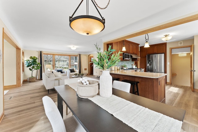 2701 Princeton Ave, Saint Louis Park, MN 55416 - dining space featuring baseboards and light wood-style flooring