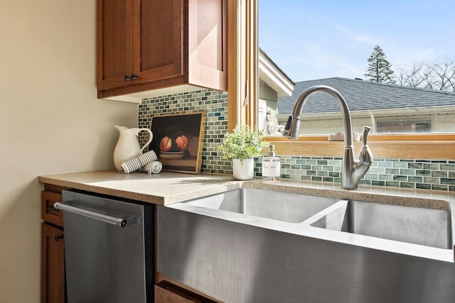 2701 Princeton Ave, Saint Louis Park, MN 55416 - kitchen view of a sink, stainless steel dishwasher, decorative backsplash, and light countertops