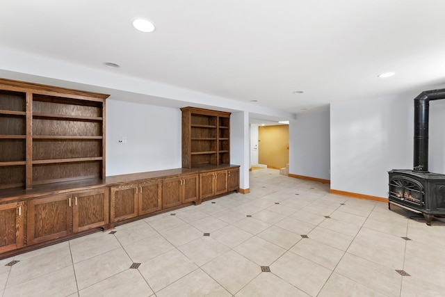 2701 Princeton Ave, Saint Louis Park, MN 55416 - unfurnished living room with a wood stove, baseboards, and recessed lighting