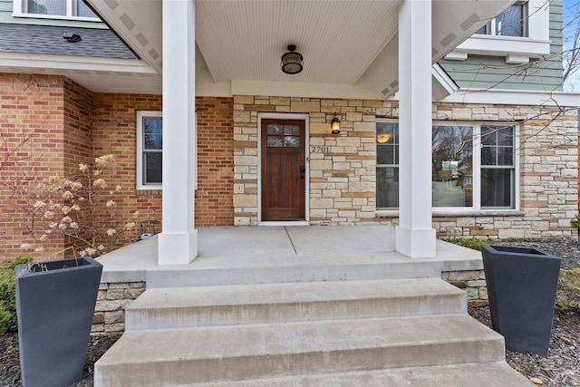 2701 Princeton Ave, Saint Louis Park, MN 55416 - property entrance featuring covered porch, stone siding, and brick siding