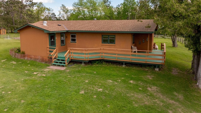 36037 678th St, Hill Lake Twp, MN 55748 - back of house with a yard, a wooden deck, and roof with shingles