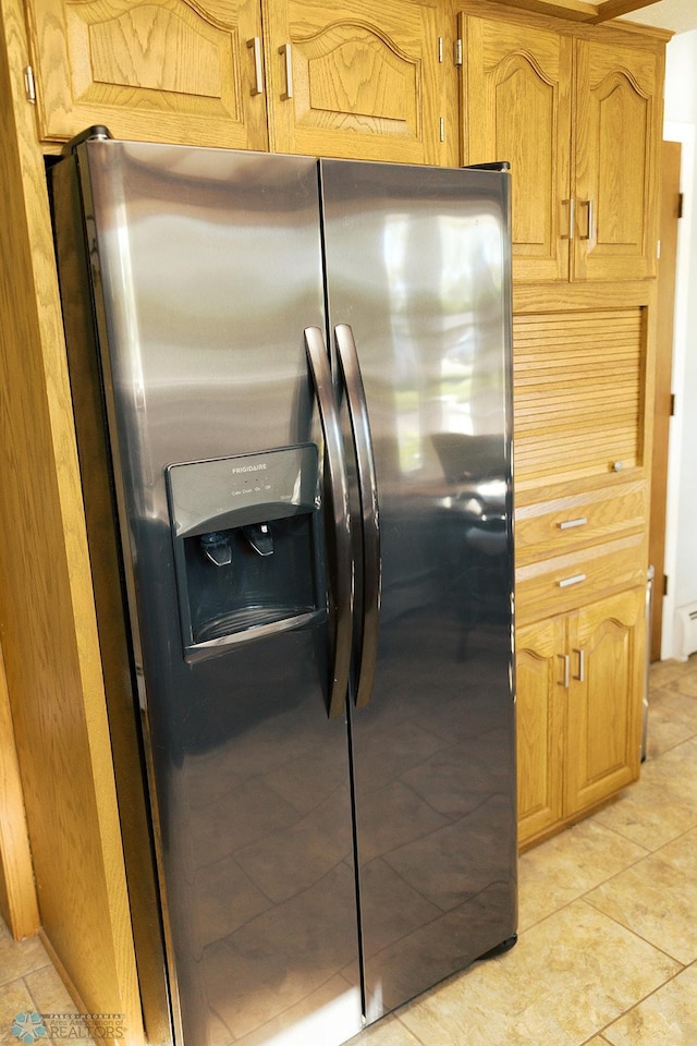 806 E St, Bottineau, ND 58318 - kitchen with stainless steel fridge and light tile patterned flooring