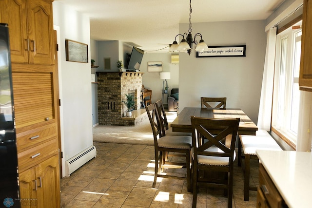 806 E St, Bottineau, ND 58318 - dining area with baseboard heating, a brick fireplace, and a chandelier