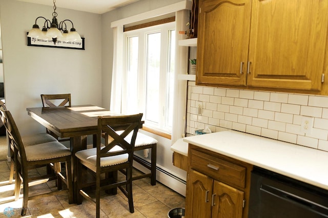 806 E St, Bottineau, ND 58318 - dining area featuring healthy amount of natural light, a chandelier, and a baseboard radiator