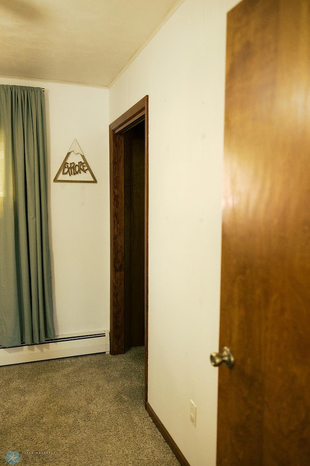 806 E St, Bottineau, ND 58318 - unfurnished bedroom featuring carpet floors, baseboard heating, and ornamental molding