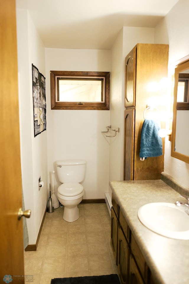 806 E St, Bottineau, ND 58318 - bathroom featuring toilet, vanity, a baseboard radiator, tile patterned floors, and baseboards