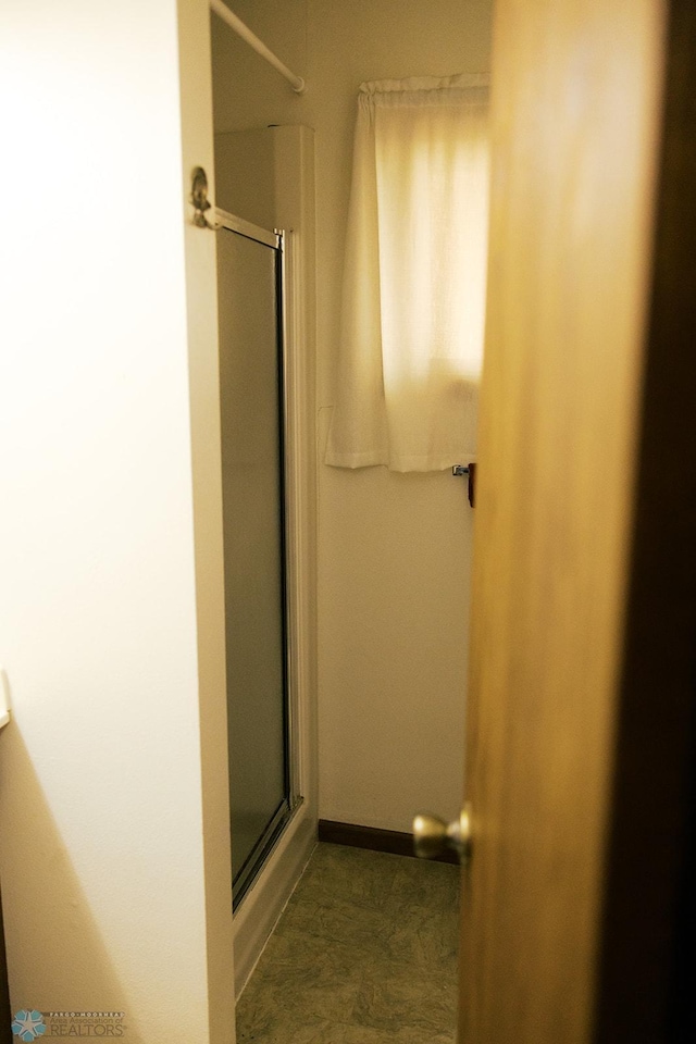 806 E St, Bottineau, ND 58318 - bathroom with a shower with door and baseboards
