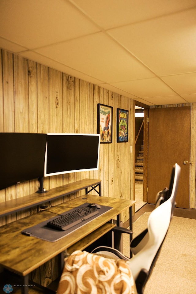 806 E St, Bottineau, ND 58318 - home office featuring wood walls, carpet floors, and a drop ceiling