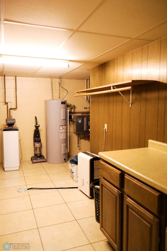 806 E St, Bottineau, ND 58318 - finished basement featuring water heater, a water softener, concrete block wall, and light tile patterned floors