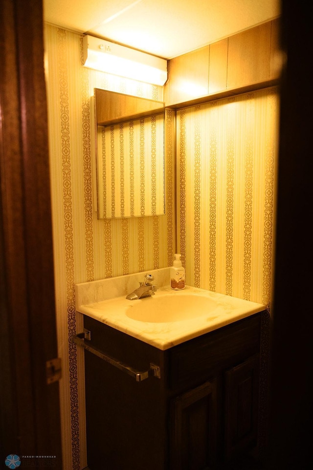 806 E St, Bottineau, ND 58318 - bathroom with wallpapered walls and vanity