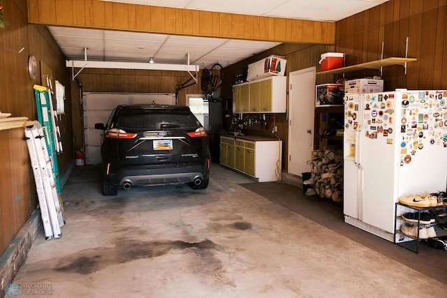 806 E St, Bottineau, ND 58318 - garage with white refrigerator with ice dispenser and wooden walls