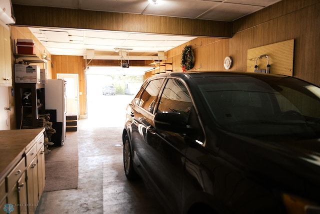 806 E St, Bottineau, ND 58318 - garage with wooden walls and freestanding refrigerator