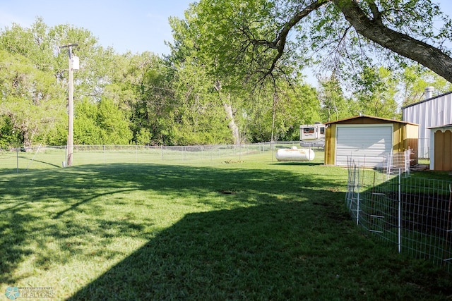 806 E St, Bottineau, ND 58318 - view of yard featuring a garage and an outbuilding