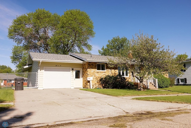 806 E St, Bottineau, ND 58318 - view of front of home featuring a garage, concrete driveway, and a front yard