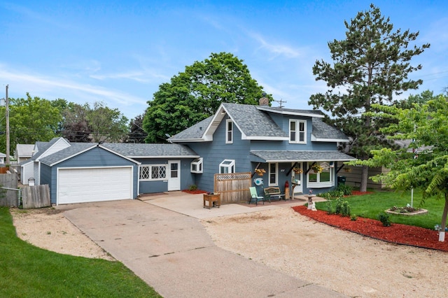 5252 5th St NE, Columbia Heights, MN 55421 - view of front of home with a shingled roof, covered porch, driveway, a chimney, and an attached garage