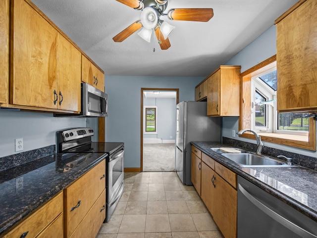 5252 5th St NE, Columbia Heights, MN 55421 - kitchen with appliances with stainless steel finishes, a ceiling fan, light tile patterned flooring, and brown cabinetry
