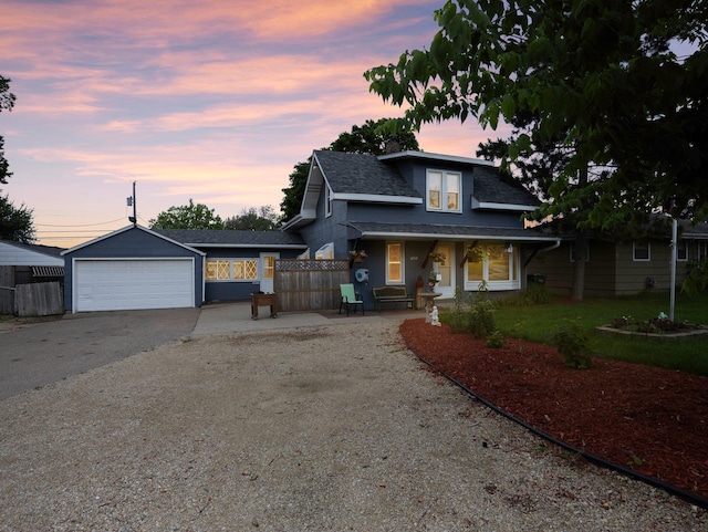5252 5th St NE, Columbia Heights, MN 55421 - bungalow-style home featuring driveway, roof with shingles, covered porch, and a garage