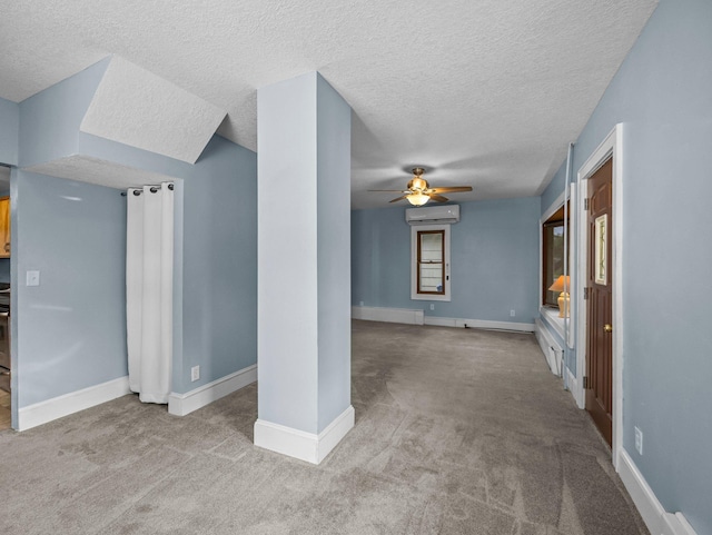 5252 5th St NE, Columbia Heights, MN 55421 - unfurnished living room featuring a ceiling fan, a textured ceiling, a wall mounted AC, and carpet floors