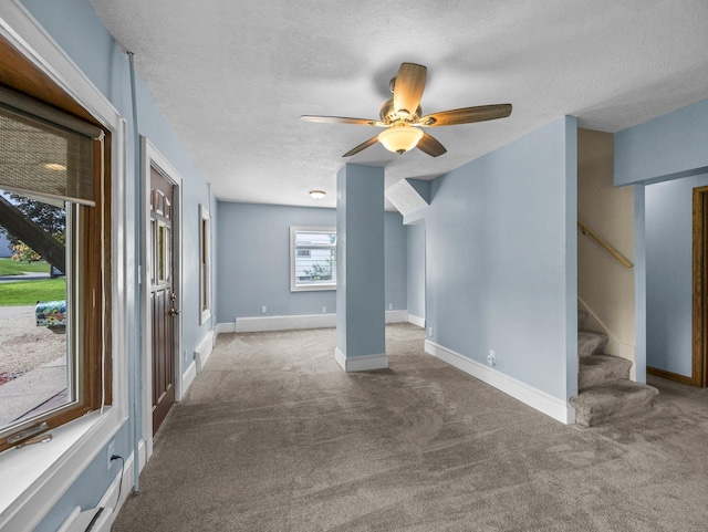 5252 5th St NE, Columbia Heights, MN 55421 - unfurnished room featuring carpet flooring, a textured ceiling, stairway, and ceiling fan