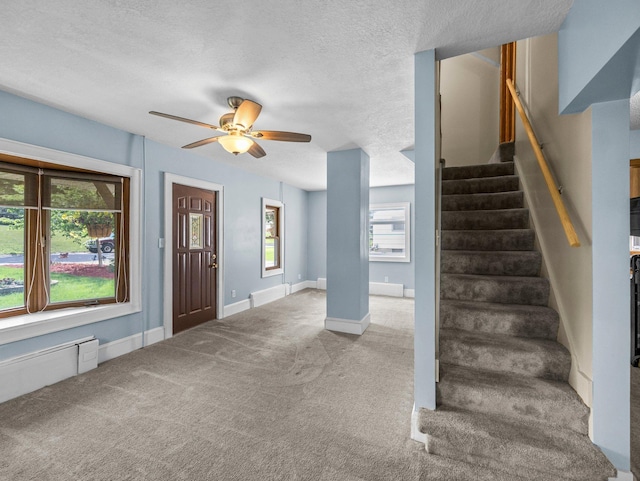5252 5th St NE, Columbia Heights, MN 55421 - carpeted foyer entrance featuring ceiling fan, stairway, and a textured ceiling