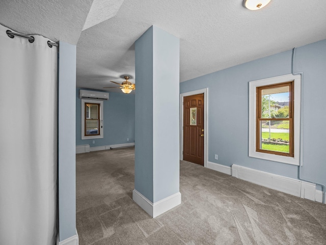 5252 5th St NE, Columbia Heights, MN 55421 - carpeted empty room with a textured ceiling, a baseboard heating unit, a ceiling fan, and a wall unit AC