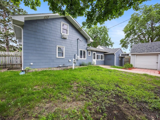 5252 5th St NE, Columbia Heights, MN 55421 - rear view of house featuring an outbuilding, a detached garage, and cooling unit