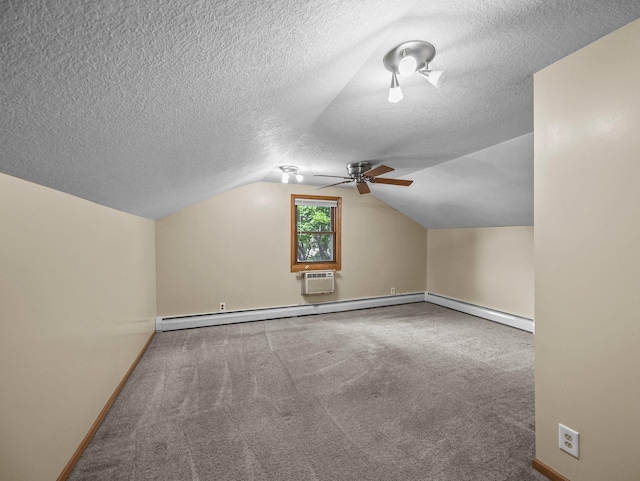 5252 5th St NE, Columbia Heights, MN 55421 - additional living space with ceiling fan, vaulted ceiling, carpet floors, a baseboard heating unit, and a textured ceiling