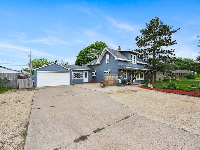 5252 5th St NE, Columbia Heights, MN 55421 - view of front facade with a porch, a chimney, a shingled roof, and driveway