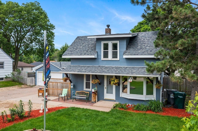 5252 5th St NE, Columbia Heights, MN 55421 - view of front of house with a shingled roof, a chimney, a garage, covered porch, and driveway