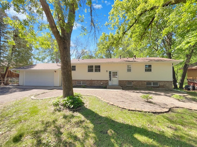 5617 220th St N, Forest Lake, MN 55025 - back of house with driveway, a garage, entry steps, and a lawn