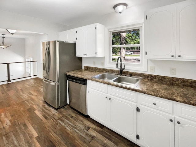 5617 220th St N, Forest Lake, MN 55025 - kitchen with appliances with stainless steel finishes, a sink, dark countertops, and dark wood-style floors