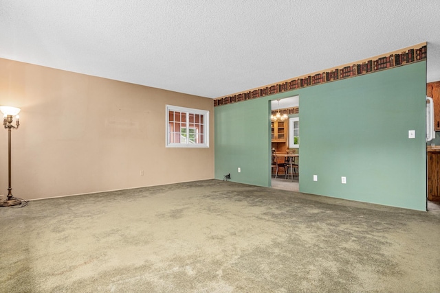 1700 Laramie Trl, Brooklyn Park, MN 55444 - empty room with a chandelier, a textured ceiling, and carpet floors