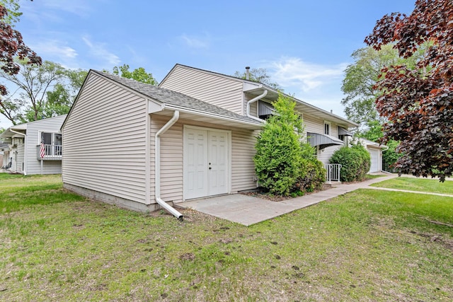1700 Laramie Trl, Brooklyn Park, MN 55444 - view of side of property featuring a yard, a shingled roof, and a garage