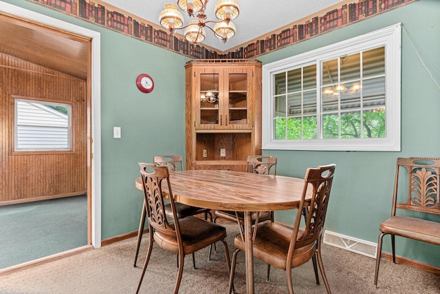 1700 Laramie Trl, Brooklyn Park, MN 55444 - carpeted dining room featuring a chandelier and baseboards