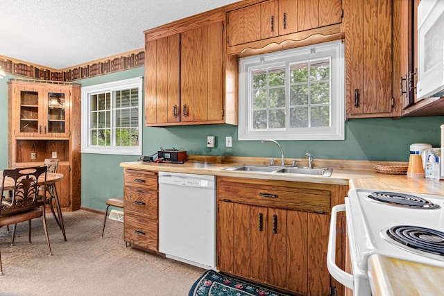 1700 Laramie Trl, Brooklyn Park, MN 55444 - kitchen with white appliances, light countertops, light carpet, healthy amount of natural light, and a textured ceiling