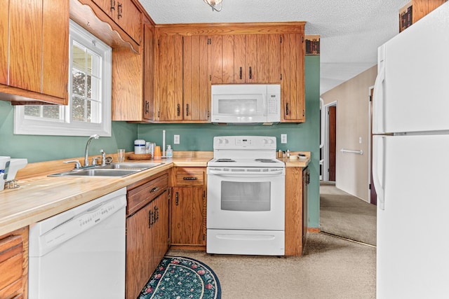 1700 Laramie Trl, Brooklyn Park, MN 55444 - kitchen featuring white appliances, light countertops, brown cabinetry, and a textured ceiling