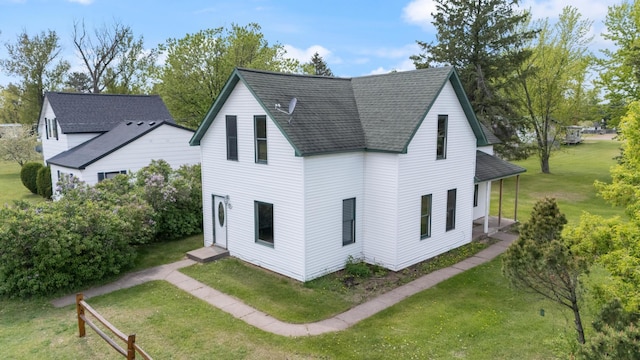 8965 Market St, Sturgeon Lake, MN 55783 - back of house with a shingled roof and a lawn