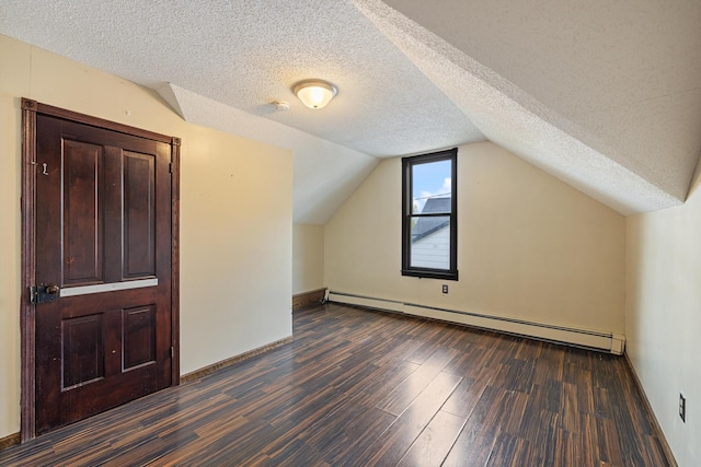 8965 Market St, Sturgeon Lake, MN 55783 - bonus room with dark wood finished floors, a baseboard radiator, a textured ceiling, lofted ceiling, and baseboards
