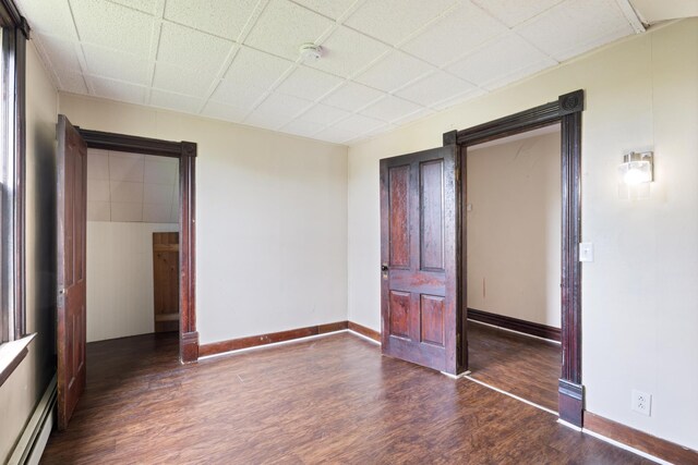 8965 Market St, Sturgeon Lake, MN 55783 - unfurnished bedroom featuring a baseboard heating unit, wood finished floors, and baseboards