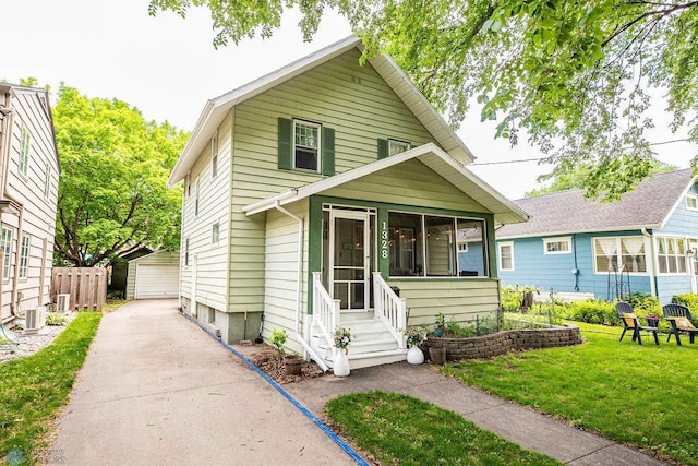 1328 6th St S, Fargo, ND 58103 - view of front of house with an outbuilding, a sunroom, and a garage