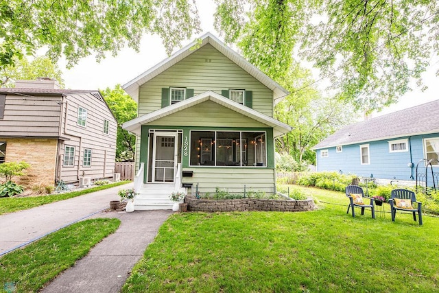 1328 6th St S, Fargo, ND 58103 - view of front of home with a front yard and a sunroom